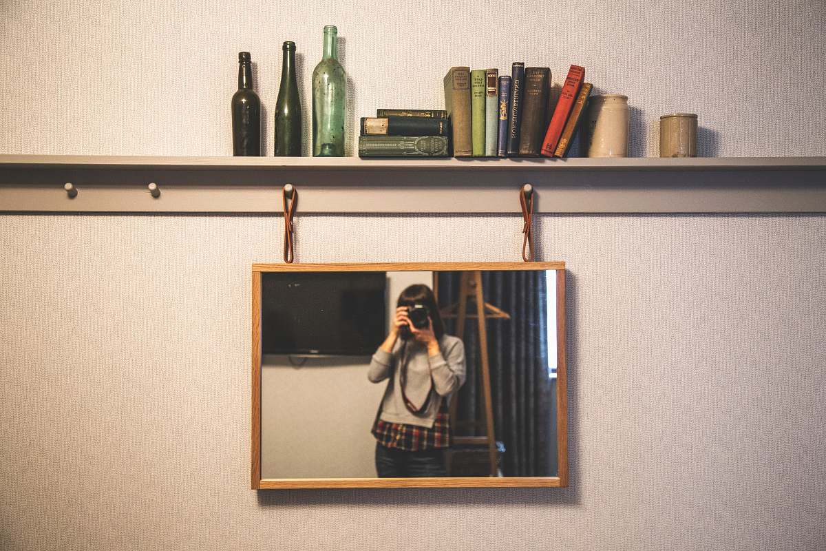united kingdom woman taking photography in front of the mirror shelf
